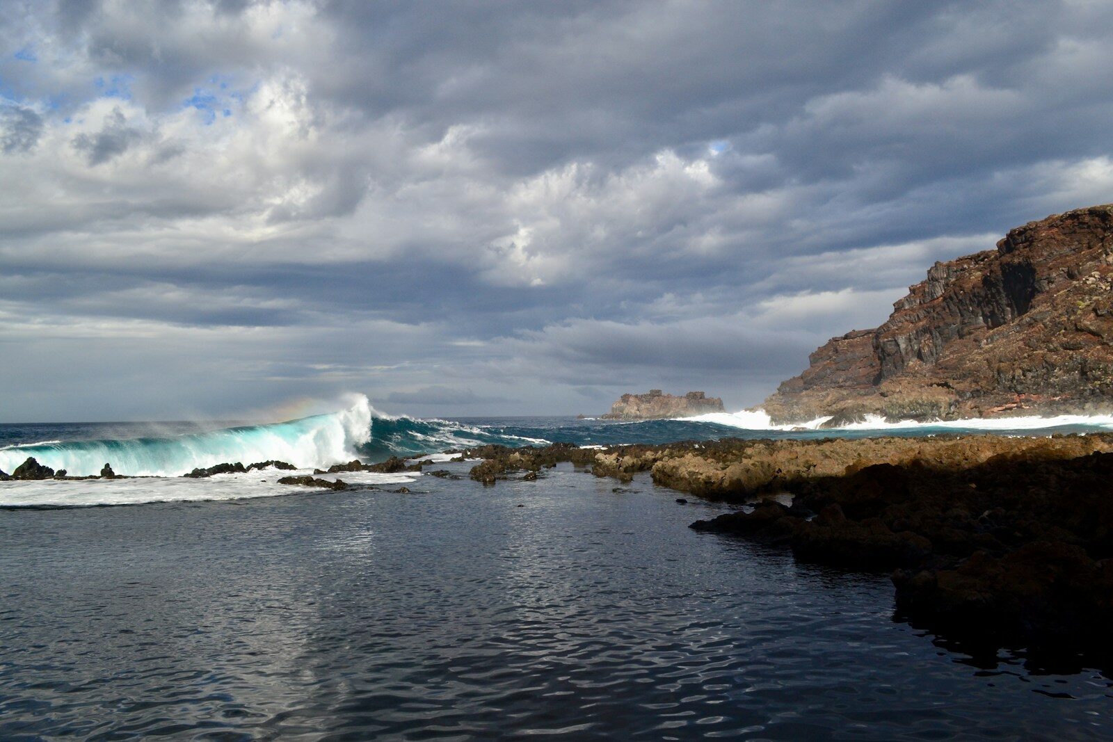 a body of water with waves coming in to shore